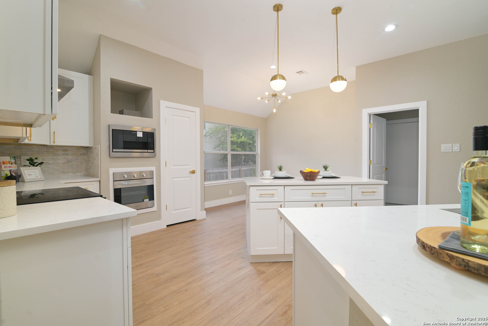 2155 North Ranch Estates Boulevard New Braunfels, TX 78130 - Photo 11 of 28 a kitchen with a sink a stove and chairs