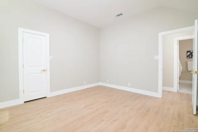 an empty room with wooden floor