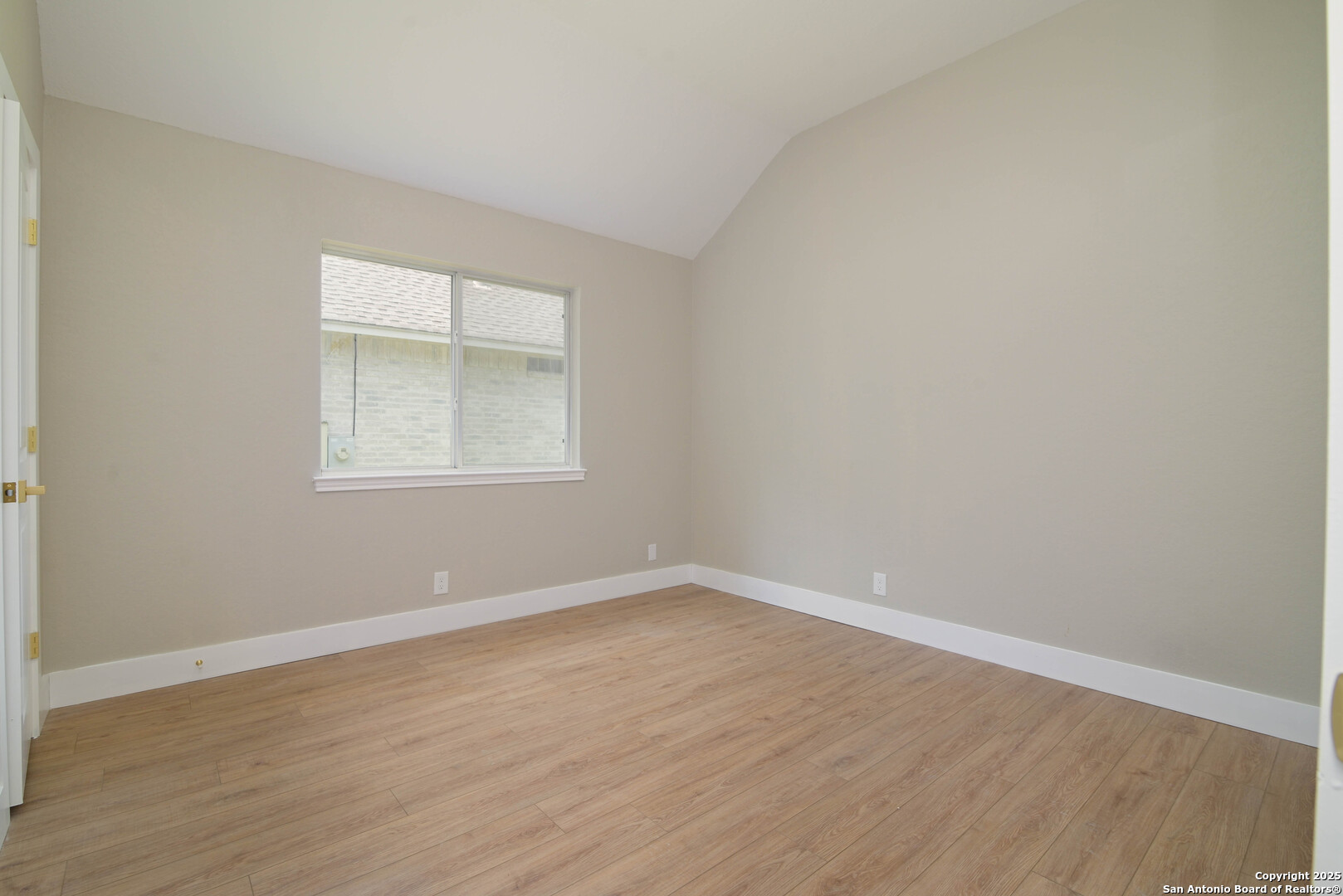2155 North Ranch Estates Boulevard New Braunfels, TX 78130 - Photo 20 of 28 an empty room with wooden floor and a window