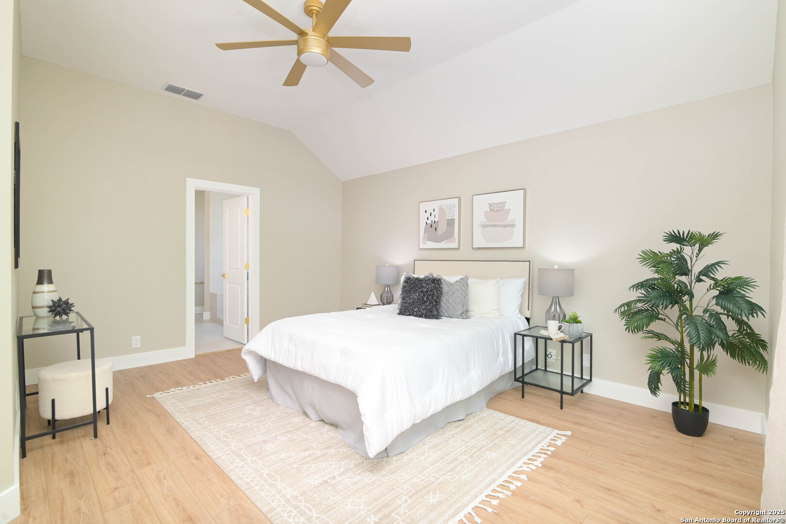 2155 North Ranch Estates Boulevard New Braunfels, TX 78130 - Photo 5 of 28 a bedroom with a large bed and a potted plant on the dresser