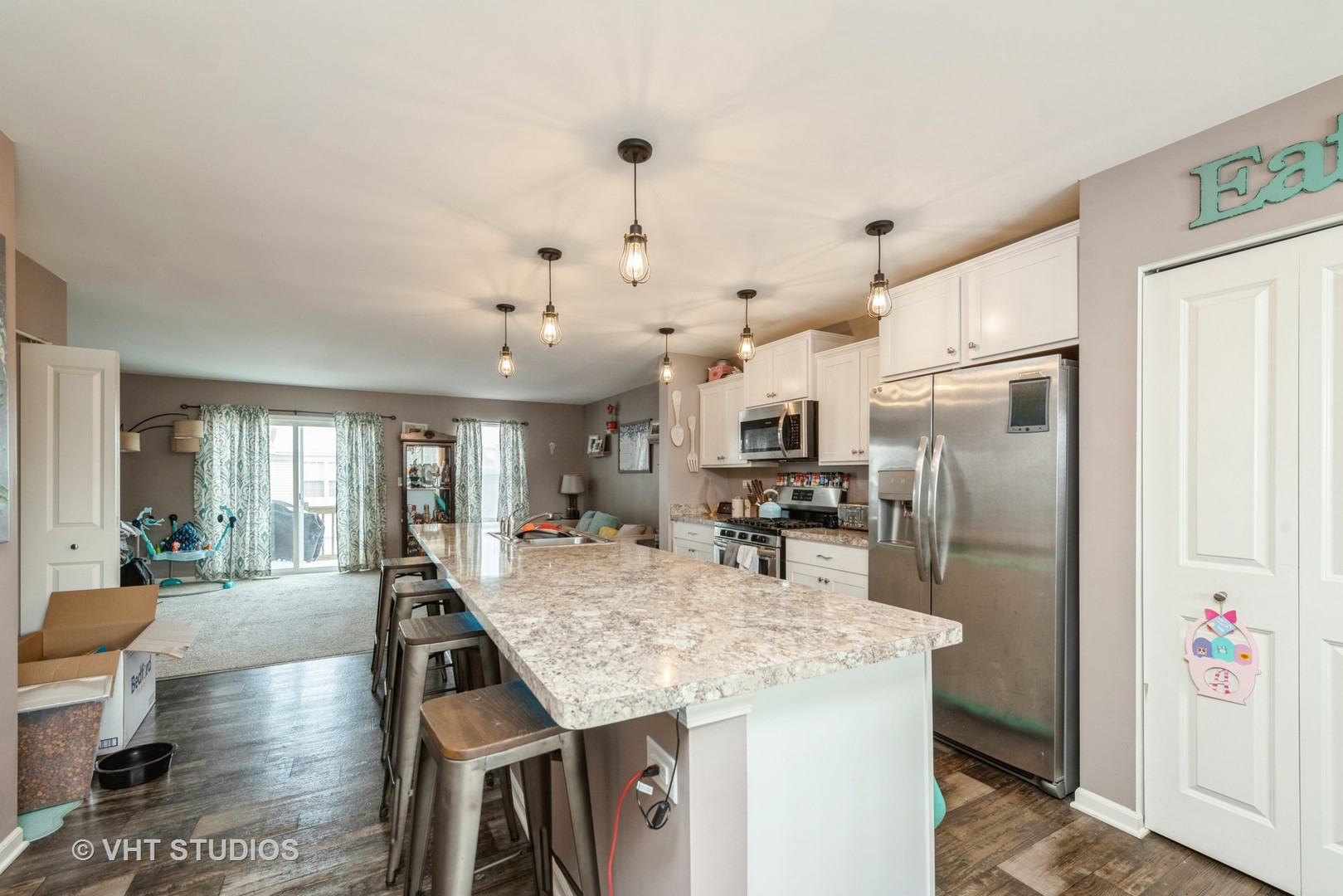 2403 Upland Road Pingree Grove, IL 60140 - Photo 6 of 15 a kitchen with stainless steel appliances granite countertop a refrigerator a sink dishwasher a dining table and chairs with wooden floor