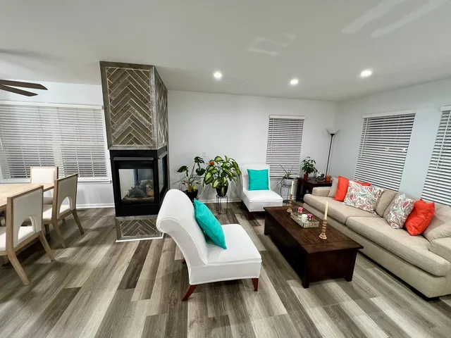 a living room with furniture and a fireplace
