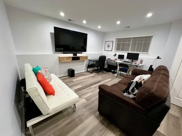 a living room with furniture and a flat screen tv