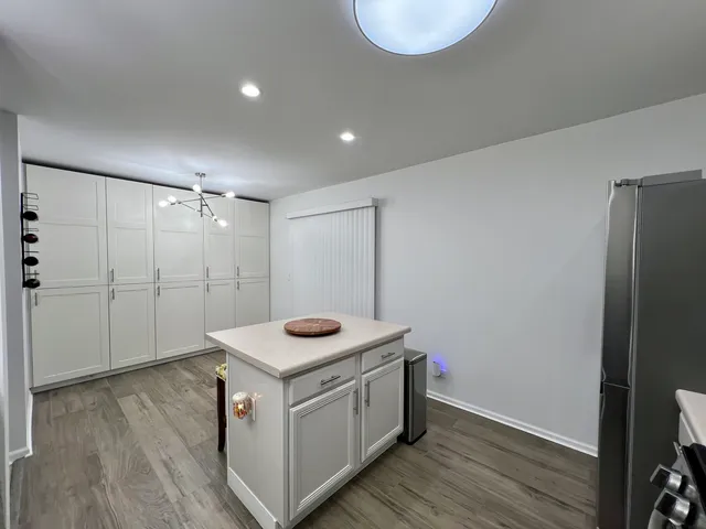 a kitchen with kitchen island granite countertop a sink stainless steel appliances and cabinets