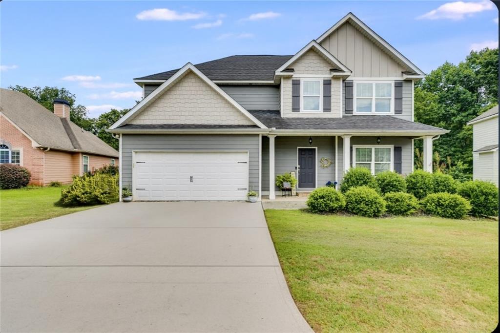 a front view of a house with garden