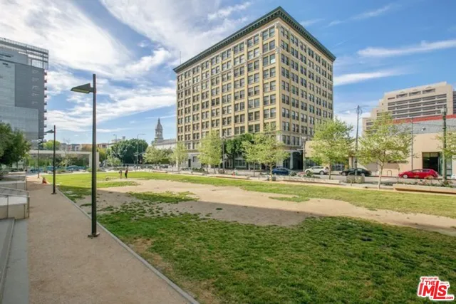 a view of a city with tall buildings and a big yard