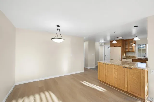 a kitchen with a stove sink and cabinets