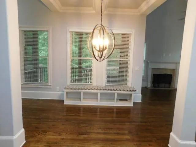 a view of a livingroom with wooden floor a fireplace