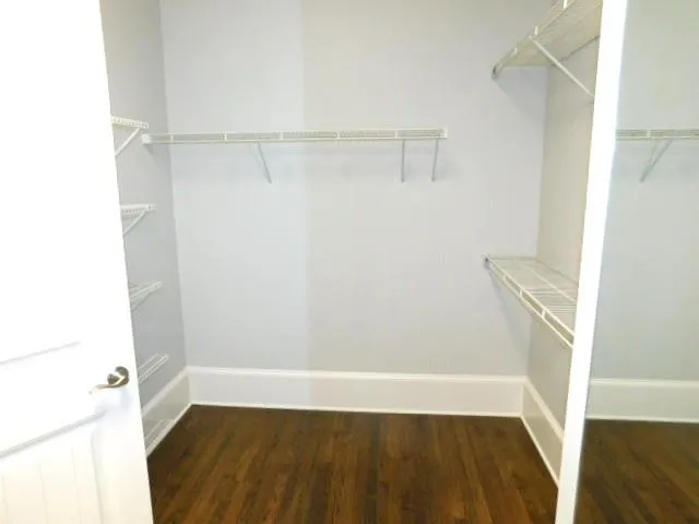 a view of walk in closet with empty racks