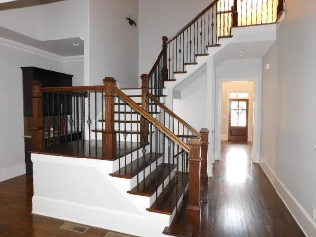 a view of staircase with white walls and railing
