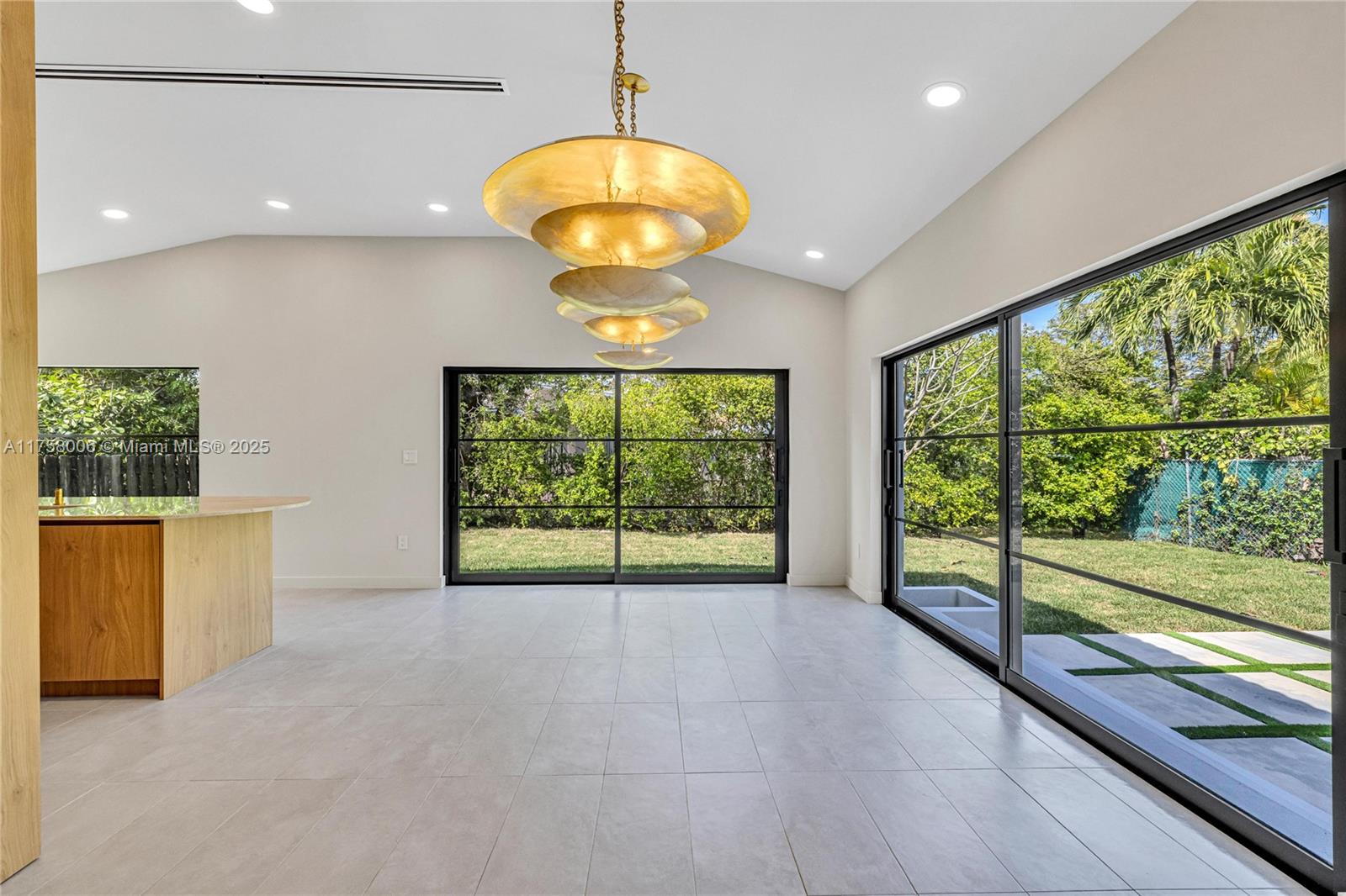 1323 Cleveland Road Miami Beach, FL 33141 - Photo 11 of 43 a view of an empty room with a window and kitchen view