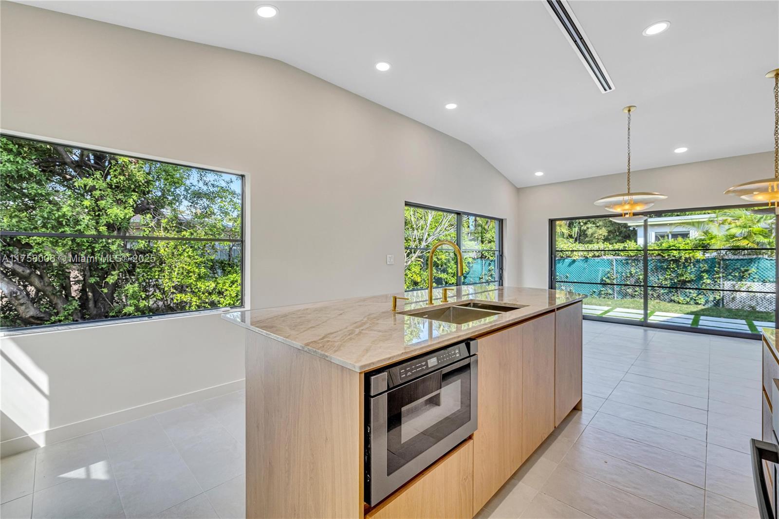 1323 Cleveland Road Miami Beach, FL 33141 - Photo 14 of 43 a kitchen with a sink and a large window