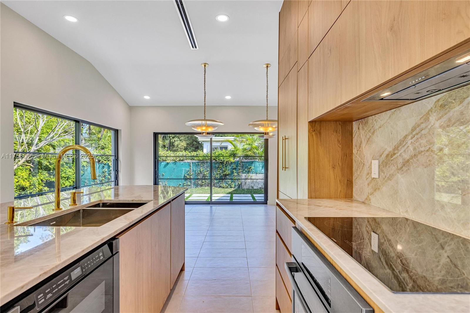 1323 Cleveland Road Miami Beach, FL 33141 - Photo 15 of 43 a kitchen with large windows and a sink