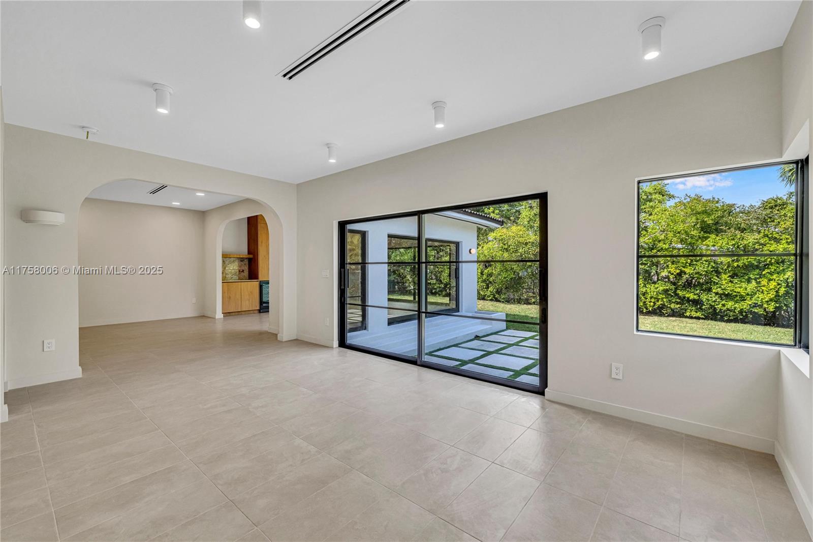 1323 Cleveland Road Miami Beach, FL 33141 - Photo 19 of 43 a view of an empty room with a fireplace and a large window