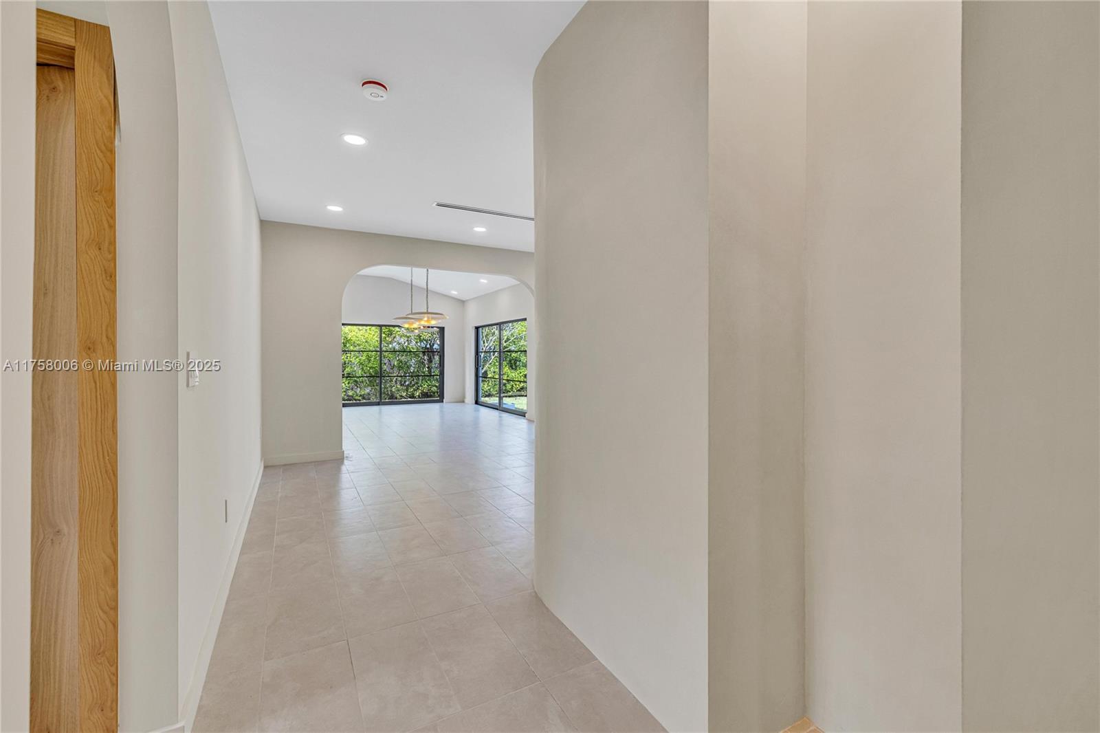 1323 Cleveland Road Miami Beach, FL 33141 - Photo 22 of 43 a view of a hallway with wooden floor and entryway