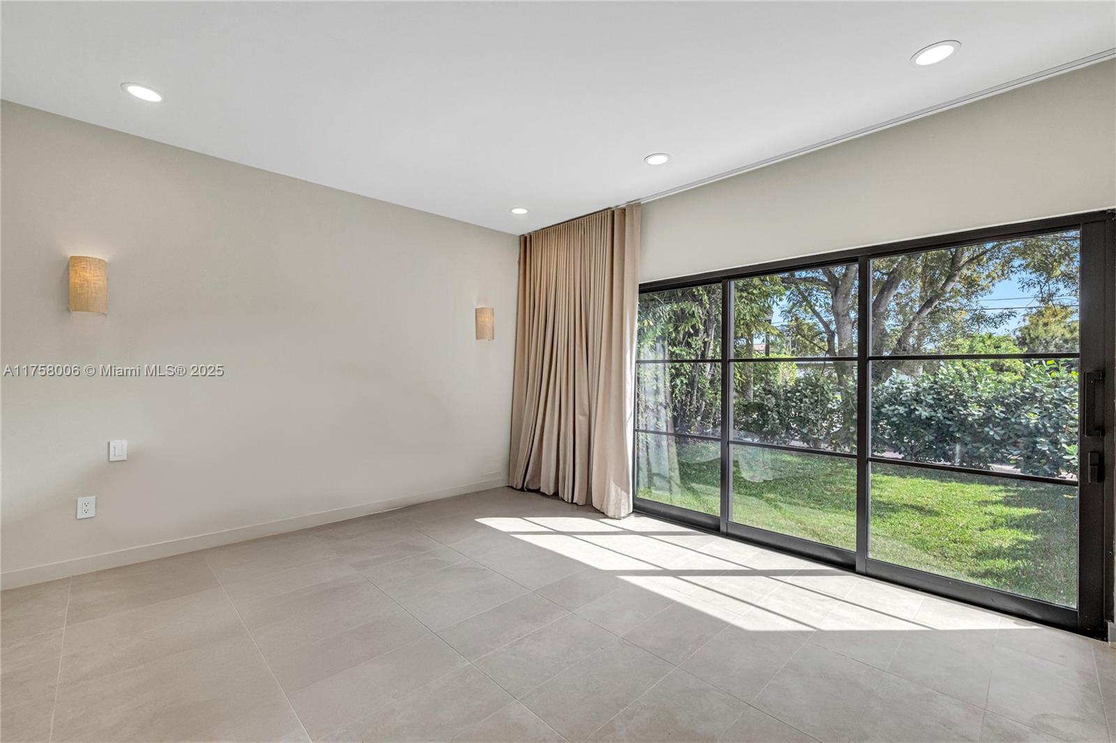 1323 Cleveland Road Miami Beach, FL 33141 - Photo 23 of 43 a view of a room with sliding glass door and road view