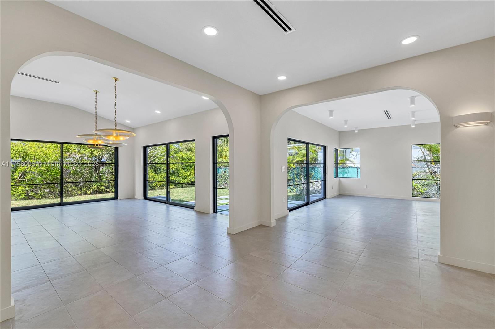 1323 Cleveland Road Miami Beach, FL 33141 - Photo 5 of 43 an empty room with windows and chandelier
