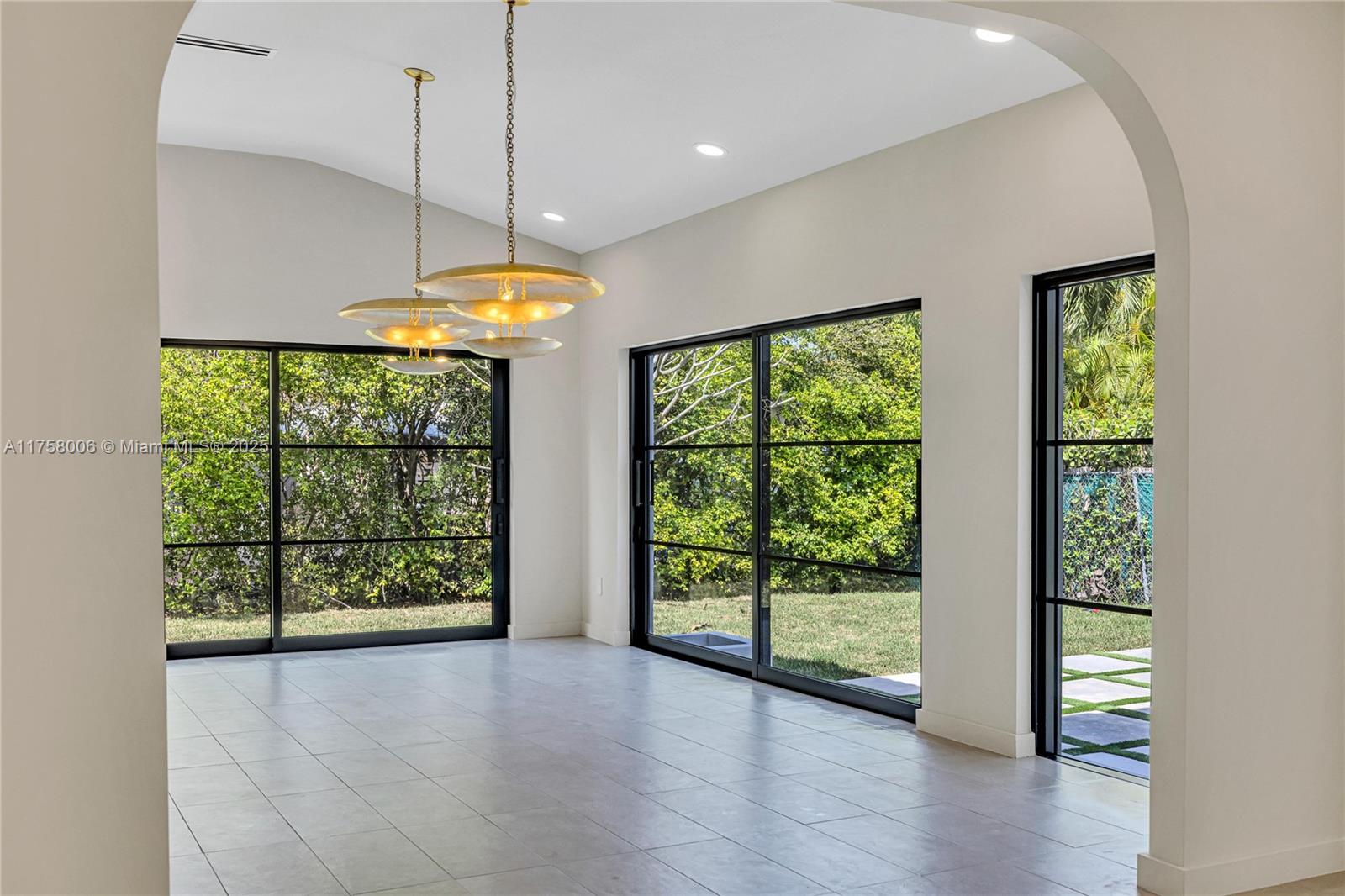1323 Cleveland Road Miami Beach, FL 33141 - Photo 6 of 43 a view of an empty room with a window and wooden floor