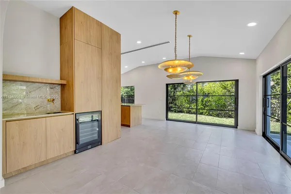 a view of a kitchen with a sink and dishwasher with wooden floor