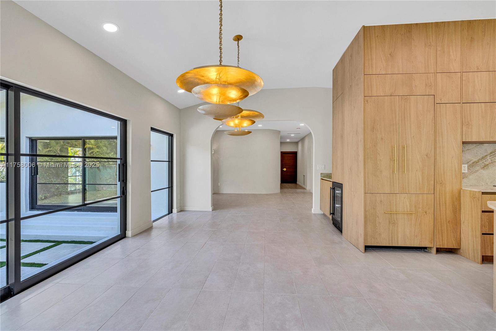 1323 Cleveland Road Miami Beach, FL 33141 - Photo 10 of 43 an empty room with chandelier fan and windows