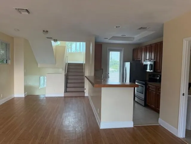 a view of a kitchen cabinets and wooden floor