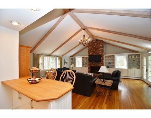 180 Rowley Bridge Road Topsfield, MA 01983 - Photo 11 of 30 a living room with furniture a fireplace and a dining table with wooden floor