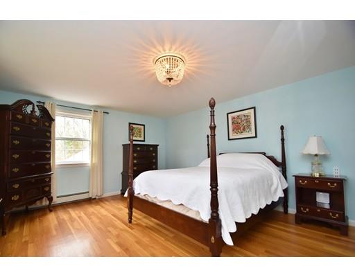 180 Rowley Bridge Road Topsfield, MA 01983 - Photo 17 of 30 a bedroom with a bed and dresser with wooden floor