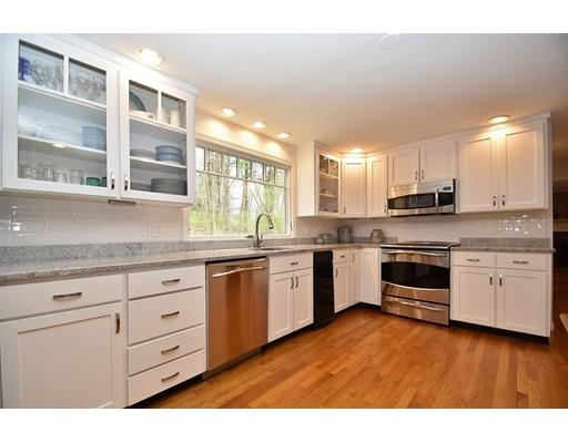 180 Rowley Bridge Road Topsfield, MA 01983 - Photo 9 of 30 a kitchen with granite countertop white cabinets and white appliances