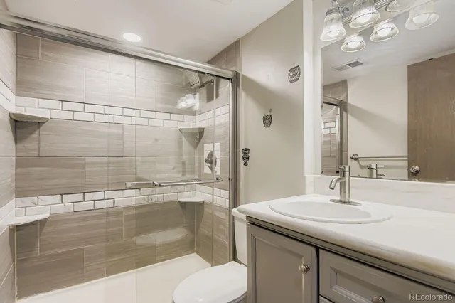 a bathroom with a sink toilet and shower
