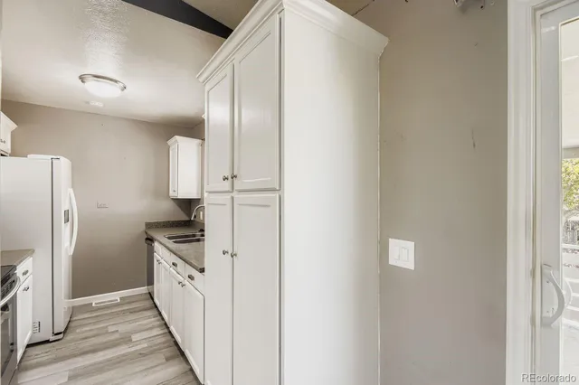 a kitchen with stainless steel appliances a refrigerator and a stove