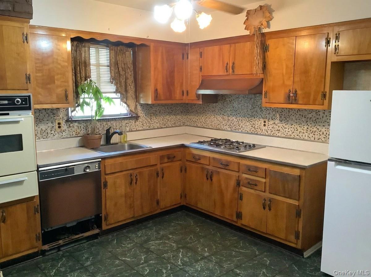 2 Sneden Court Spring Valley, NY 10977 - Photo 2 of 13 a kitchen with stainless steel appliances granite countertop a sink a stove and a refrigerator