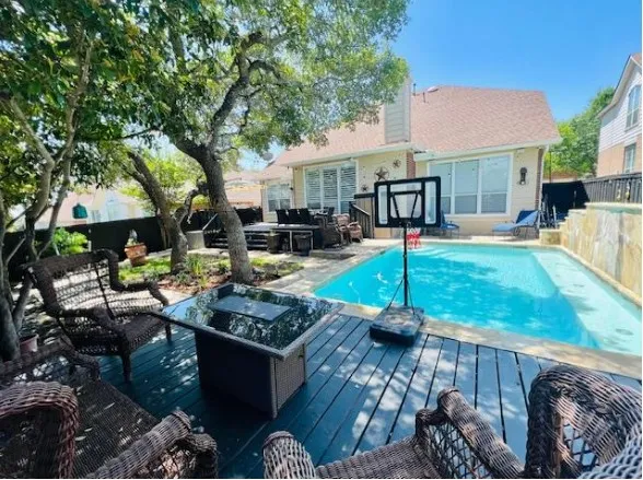 a front view of a house with swimming pool garden and outdoor seating