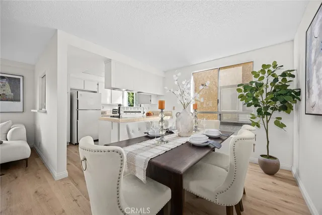 a living room with furniture a potted plant and a table