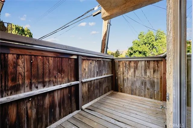 a view of balcony with wooden floor