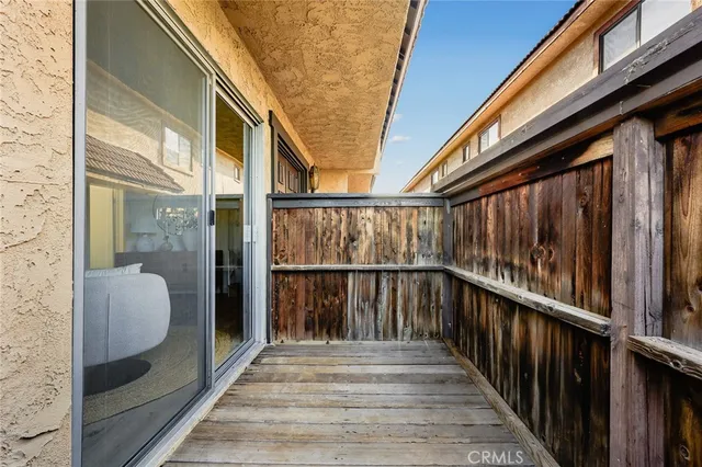 a view of balcony with wooden floor and door