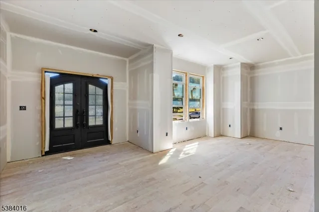 an empty room with closet and a window