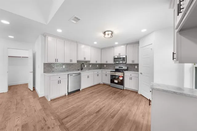 an empty room with a ceiling fan and window