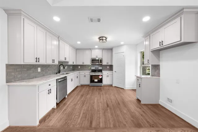 an empty room with a ceiling fan and a window