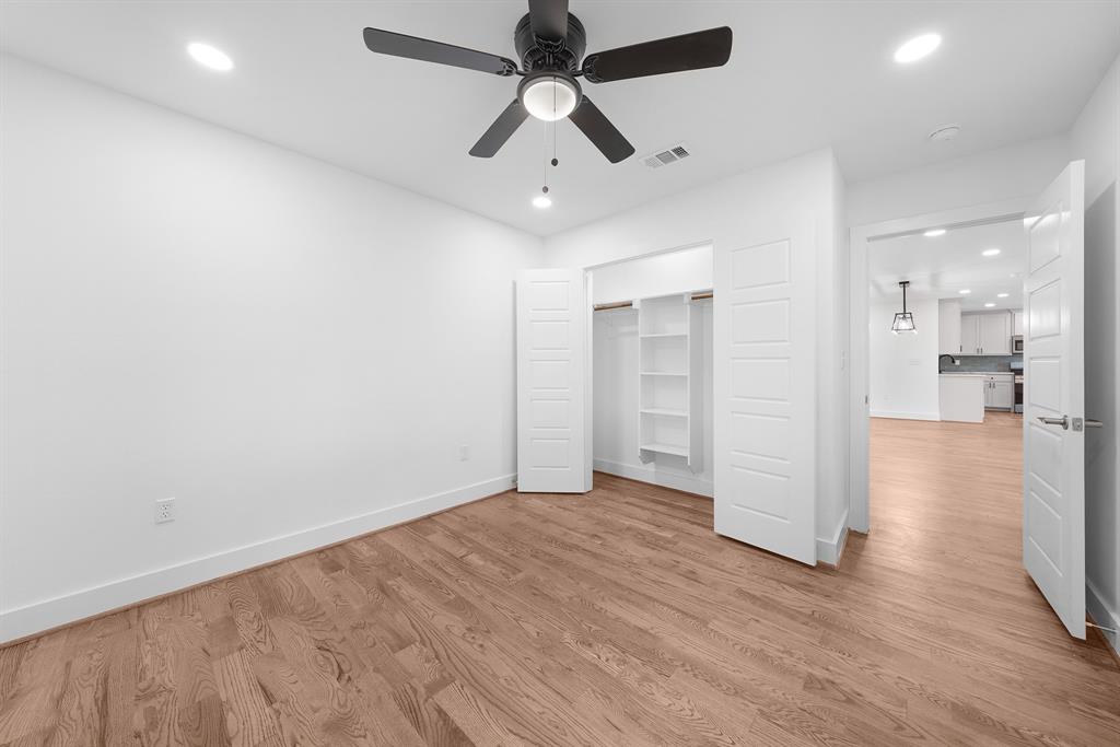 104 Mockingbird Street Ector, TX 75439 - Photo 20 of 40 an empty room with wooden floor and ceiling fan