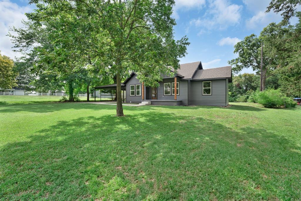 104 Mockingbird Street Ector, TX 75439 - Photo 2 of 40 a view of a house with a yard