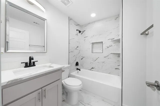 a view of a backyard with potted plants and a large tree