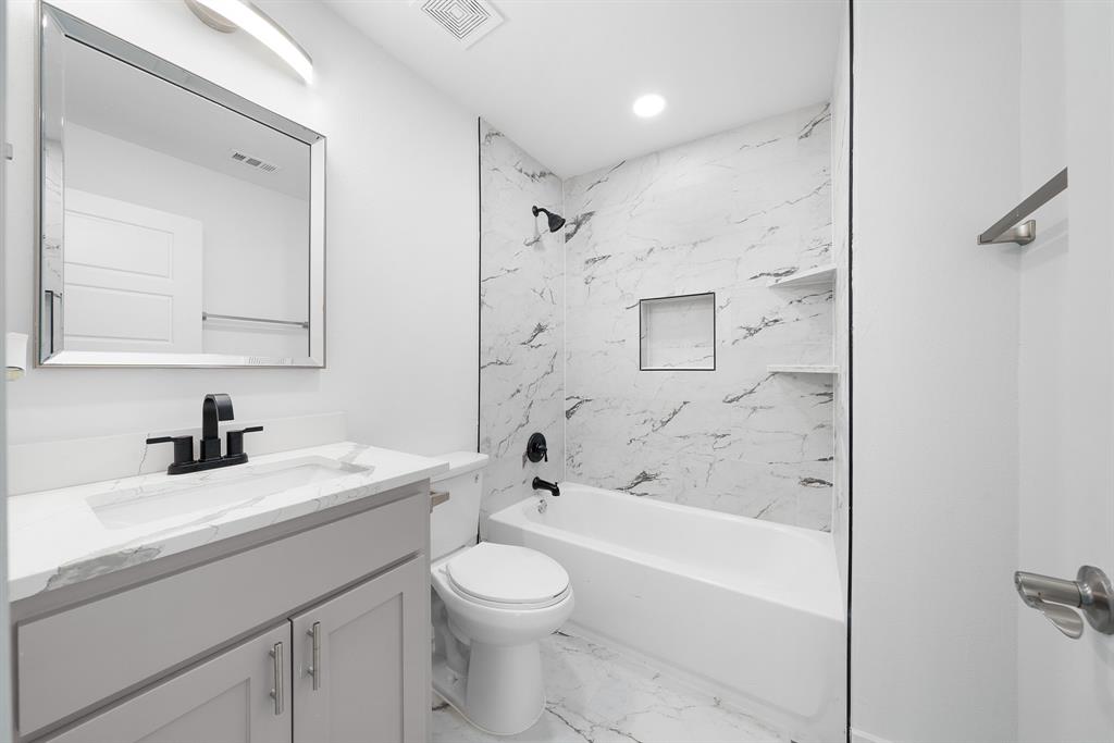 104 Mockingbird Street Ector, TX 75439 - Photo 23 of 40 a bathroom with a sink a toilet and shower