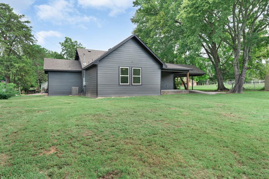 104 Mockingbird Street Ector, TX 75439 - Photo 40 of 40 a house that has a tree in front of it