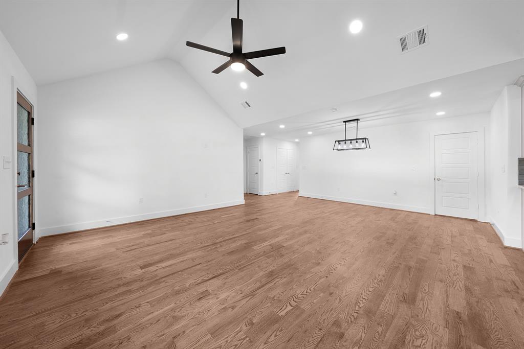 104 Mockingbird Street Ector, TX 75439 - Photo 7 of 40 an empty room with wooden floor and windows