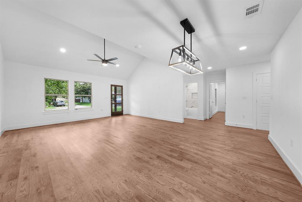 104 Mockingbird Street Ector, TX 75439 - Photo 10 of 40 a view of empty room with wooden floor and windows