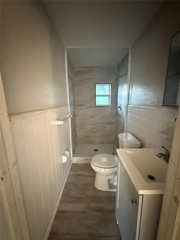 a bathroom with a toilet and shower