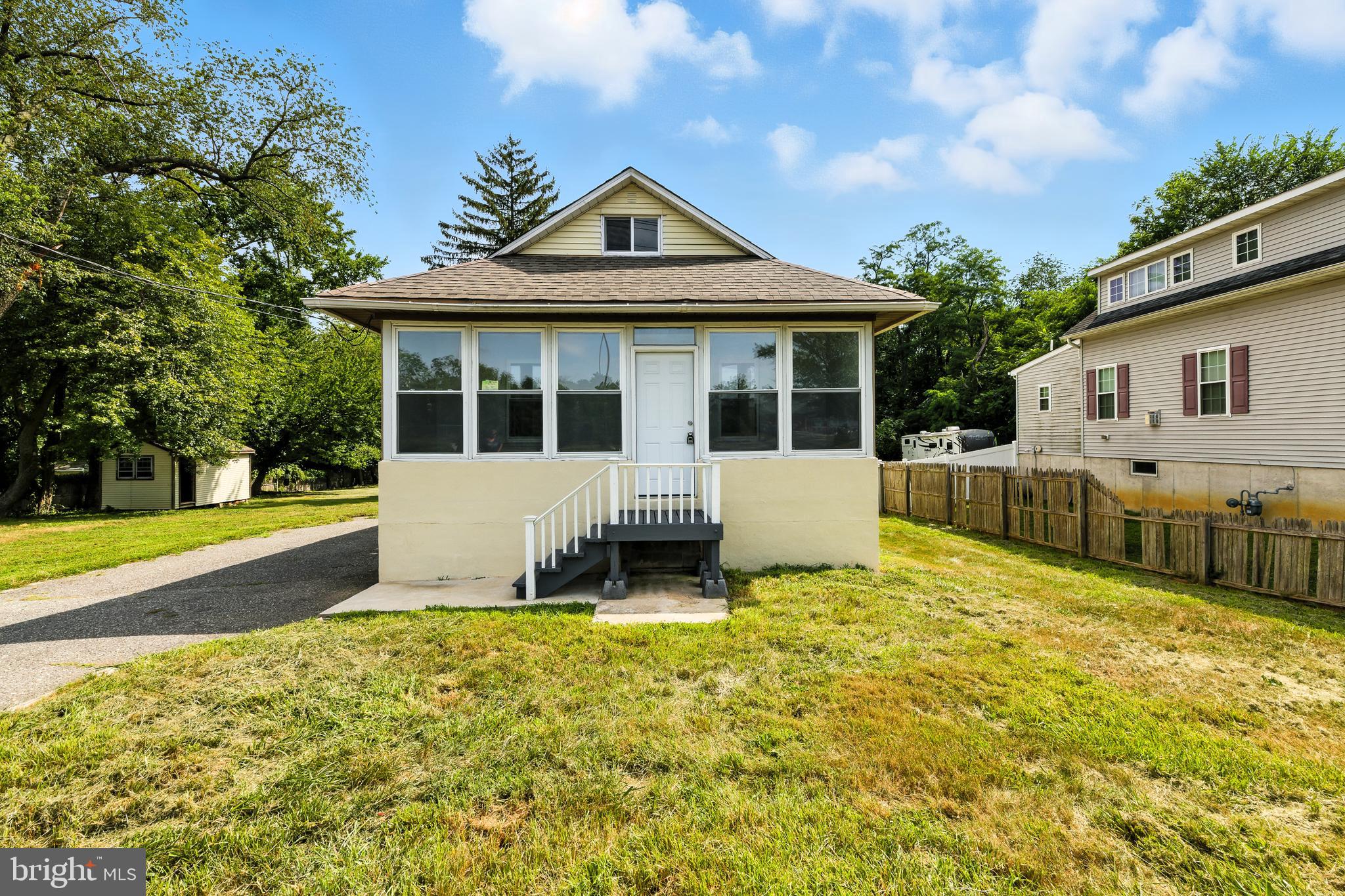 a front view of a house with a yard outdoor seating and garage