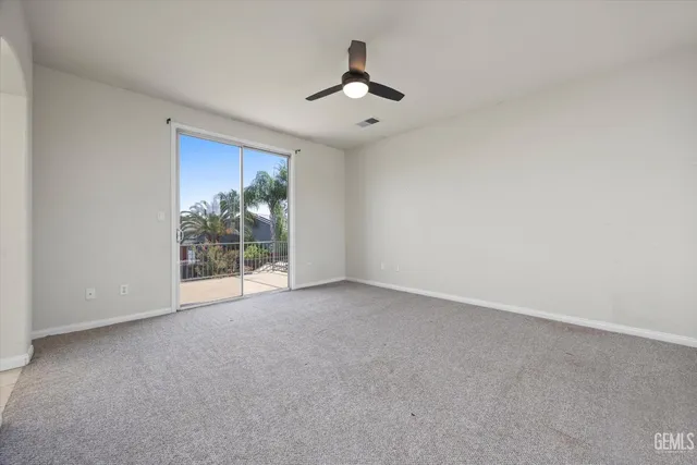 a spacious bathroom with a granite countertop sink a large mirror and a bathtub