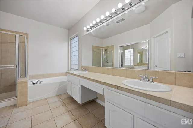 a view of a house with a yard and potted plants