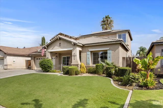 a view of a hallway with wooden floor and a chandelier